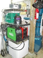 The cart has two welding tanks in the back   ,argon and mix ,a power bar and three air control valves. a bar fridge on the bottom for the ice cold drinks, Water and Dr Pepper. ,a high output air compressor behind the fridge for the plasma cutter. The ever